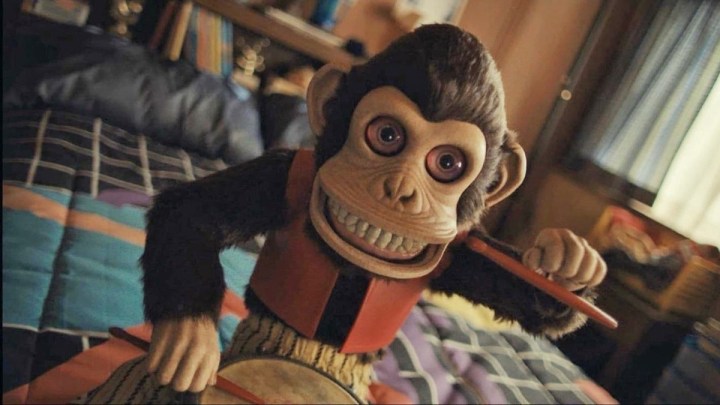 Humanoid monkey in red clothing indoors