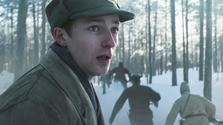 Man standing in dark forest scene